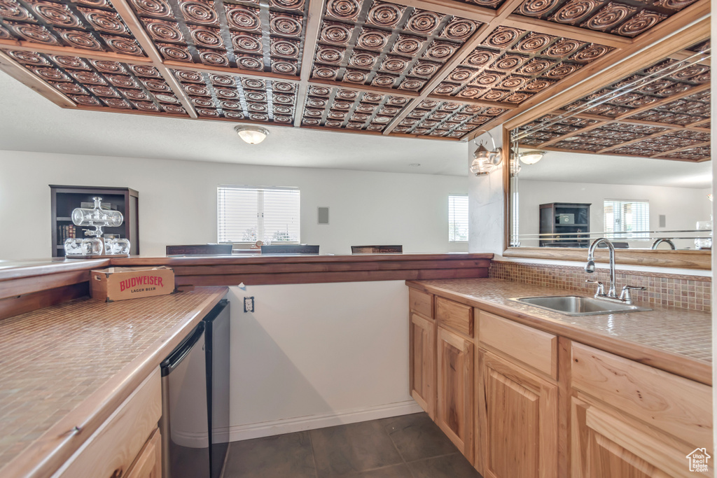 Kitchen with healthy amount of natural light, an ornate ceiling, and backsplash