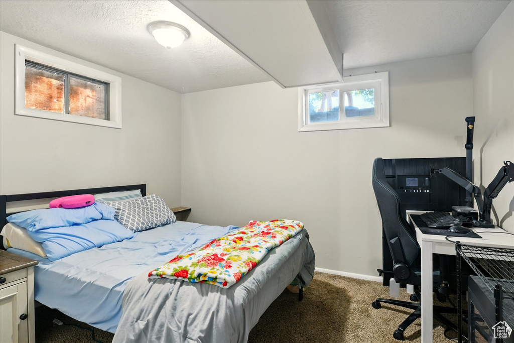 Bedroom featuring carpet flooring and baseboards