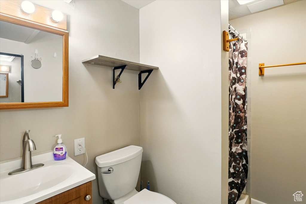 Full bathroom featuring vanity and toilet