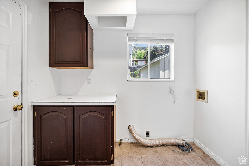 Washroom with cabinet space, washer hookup, and hookup for an electric dryer