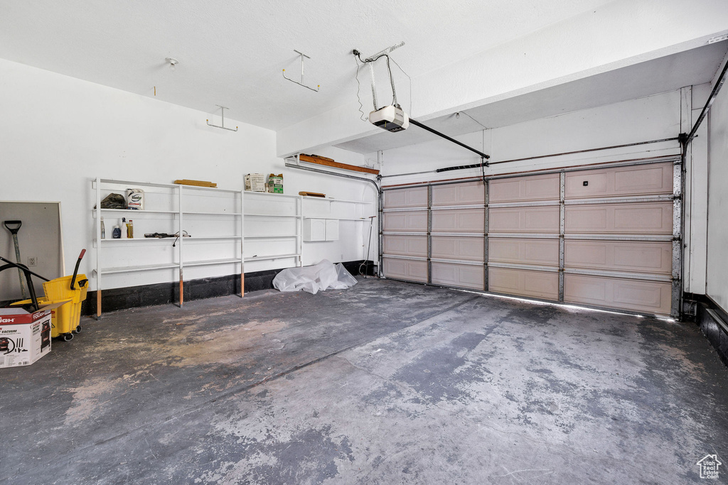 Garage featuring a garage door opener