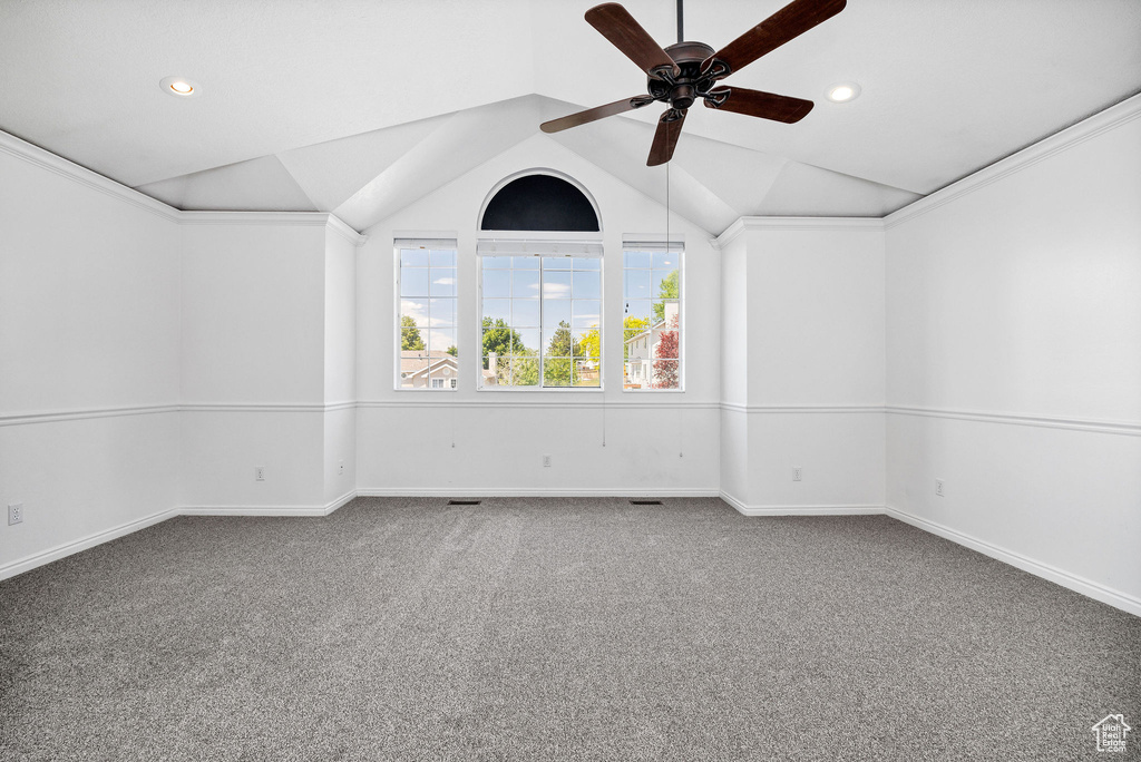 Carpeted empty room featuring lofted ceiling, recessed lighting, and ceiling fan
