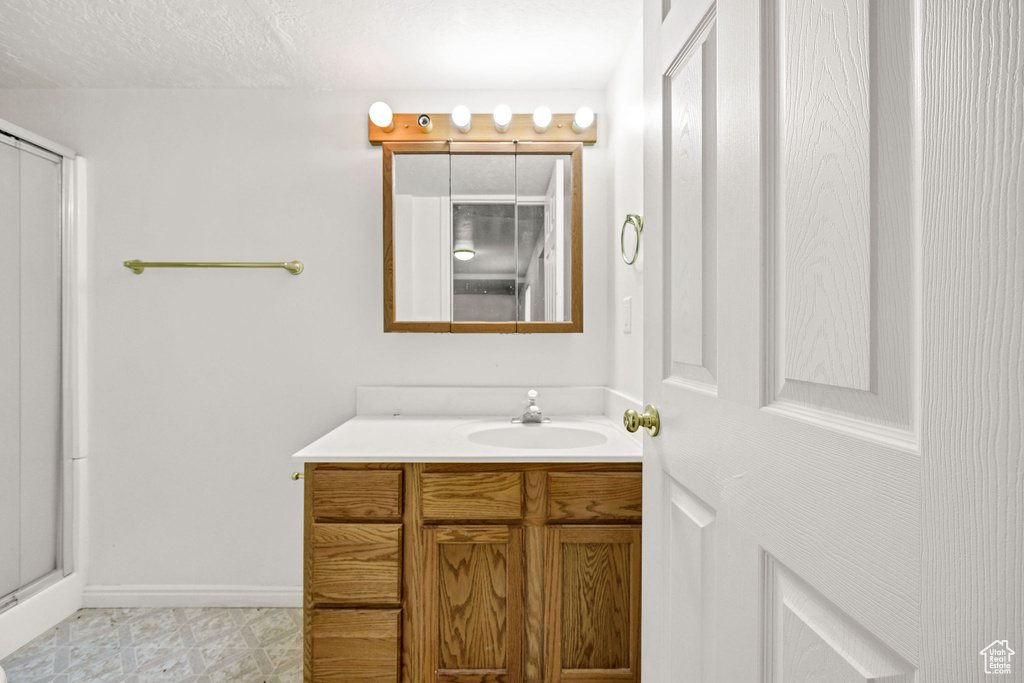 Full bath featuring vanity and a stall shower
