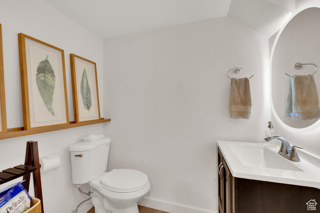 Half bath featuring vanity and toilet