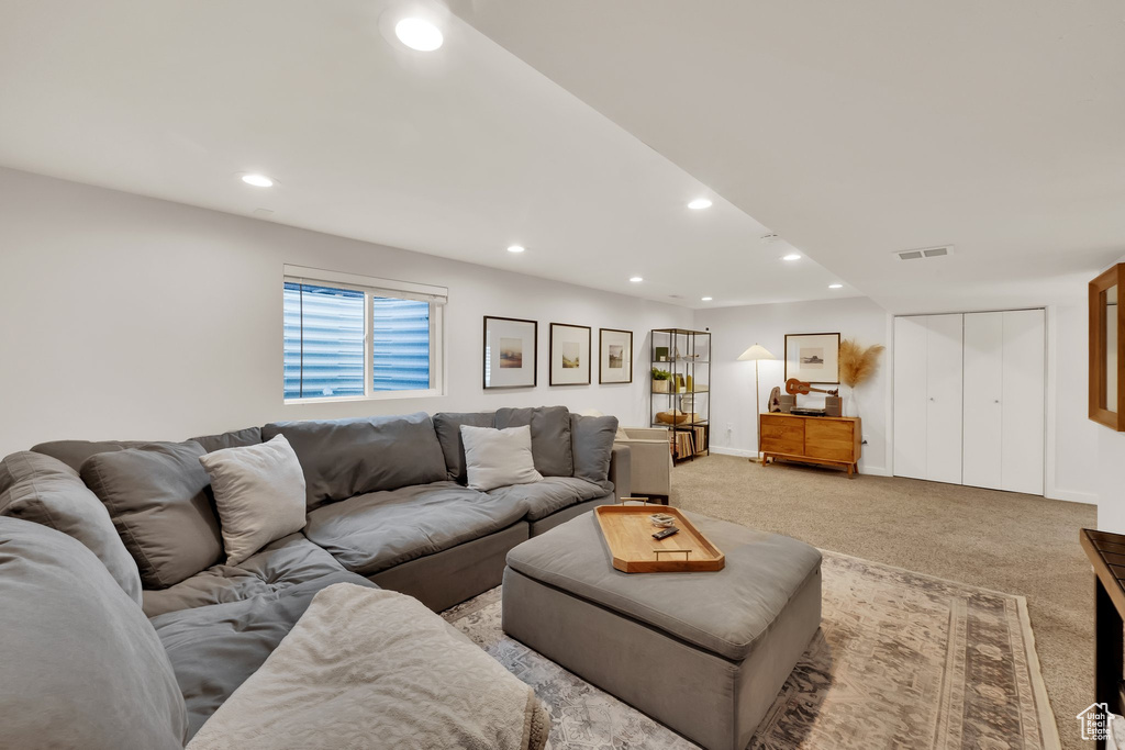 Living room with recessed lighting and light carpet