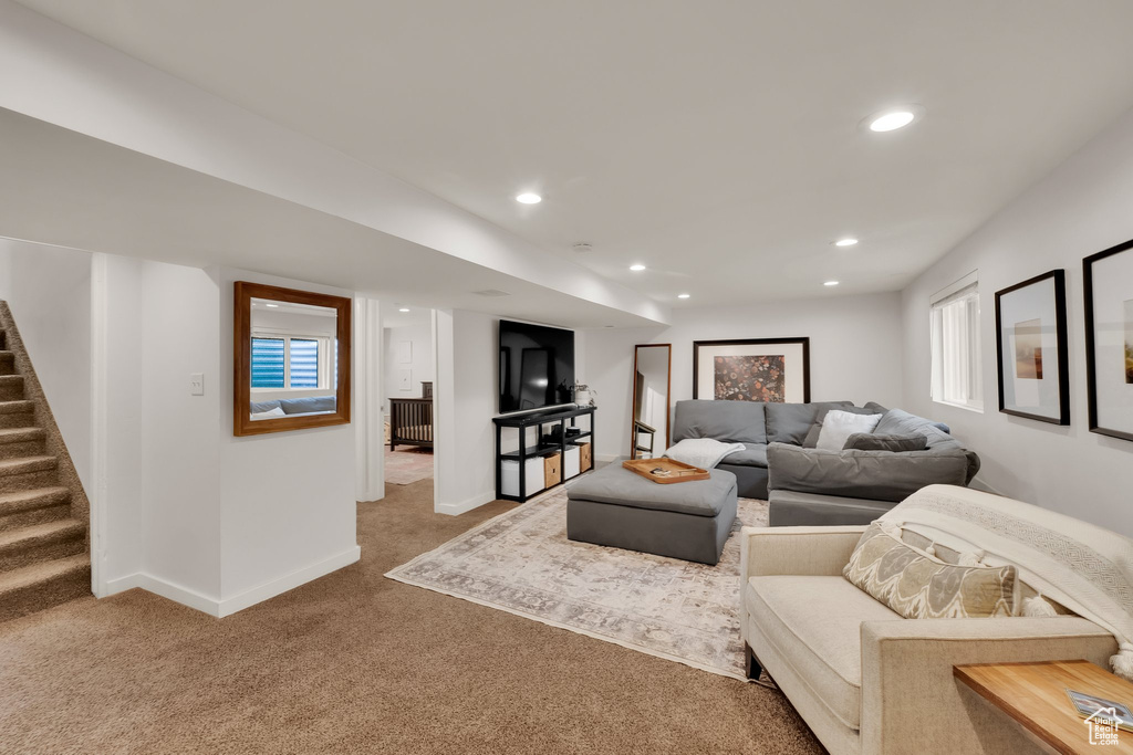 Living room with carpet floors, stairway, baseboards, and recessed lighting