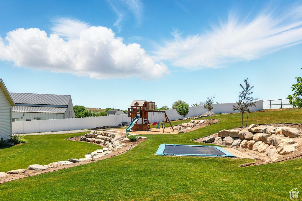 Fenced backyard with a playground