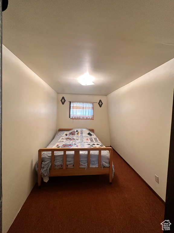 Bedroom with dark colored carpet