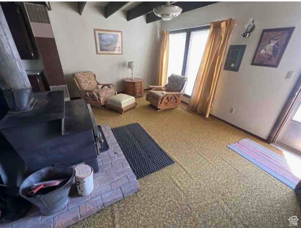 Sitting room with carpet and beam ceiling