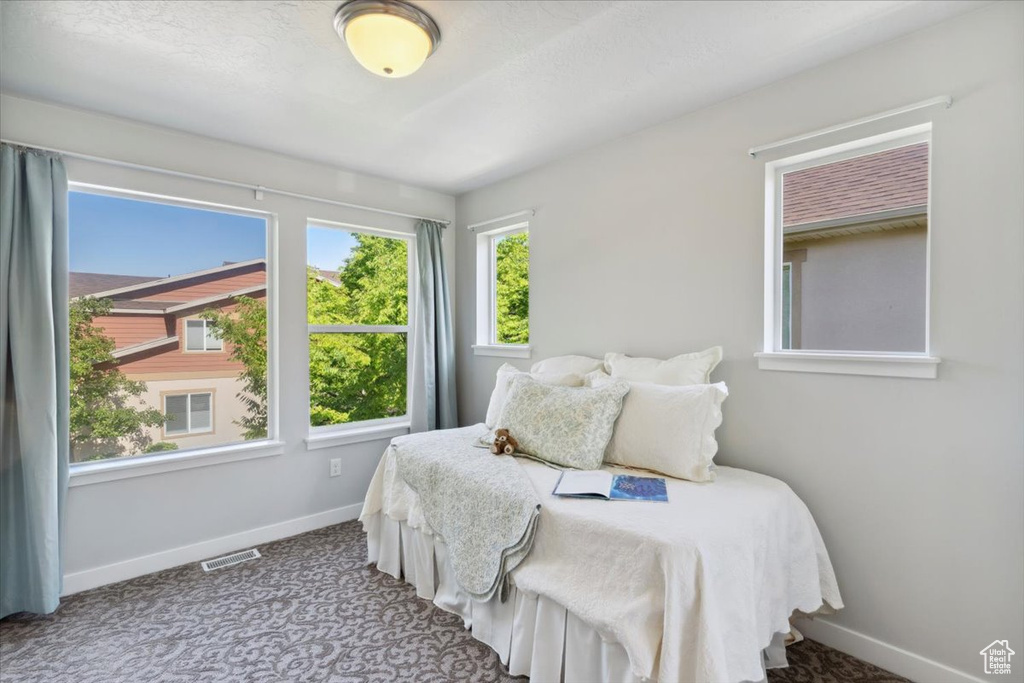 Carpeted bedroom featuring baseboards
