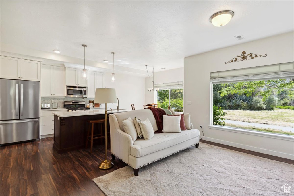 Living room featuring dark wood-style flooring and recessed lighting