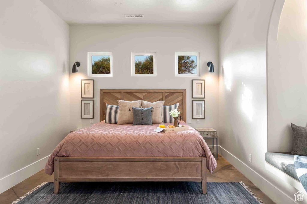 Bedroom featuring baseboards and arched walkways