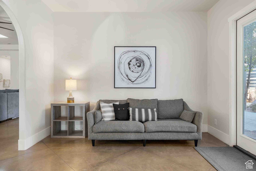 Living room with arched walkways and baseboards