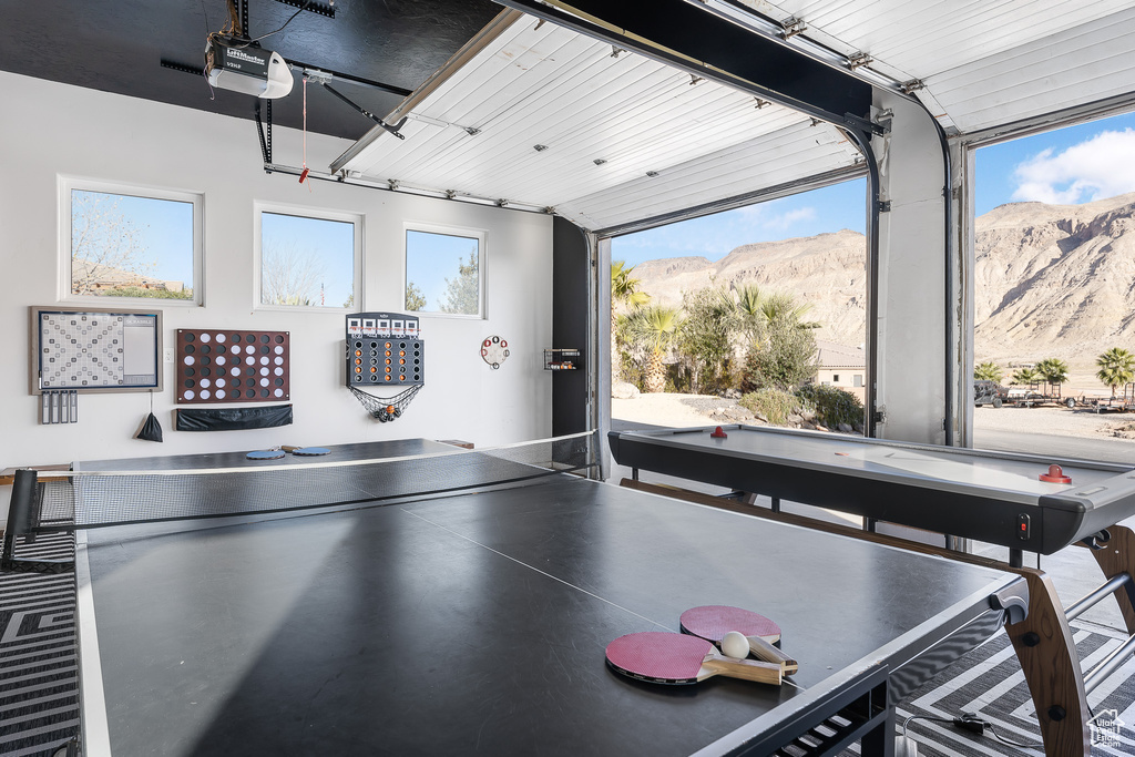 Game room featuring a mountain view and a garage