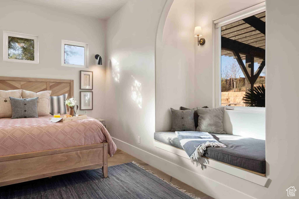 Carpeted bedroom with baseboards and access to exterior