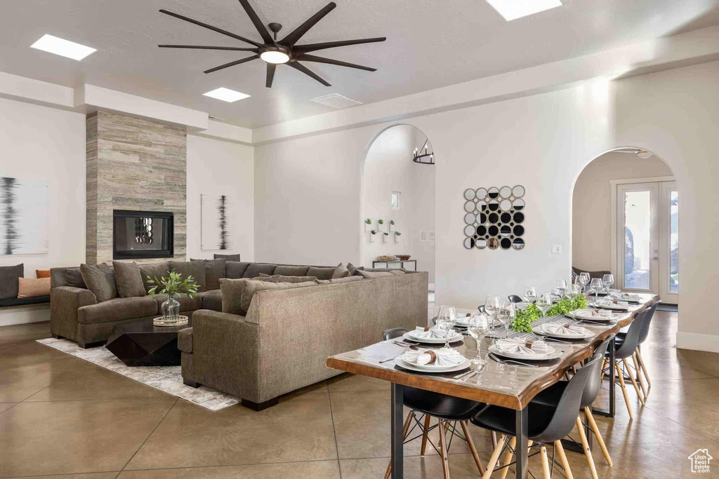 Dining area with arched walkways and ceiling fan