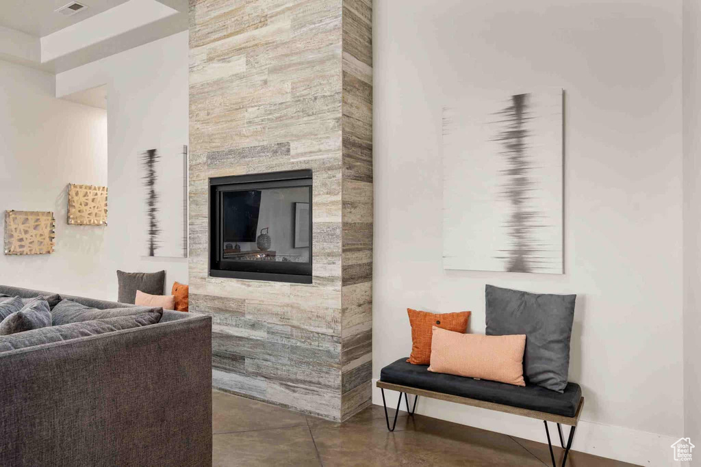 Living area featuring a fireplace and finished concrete floors