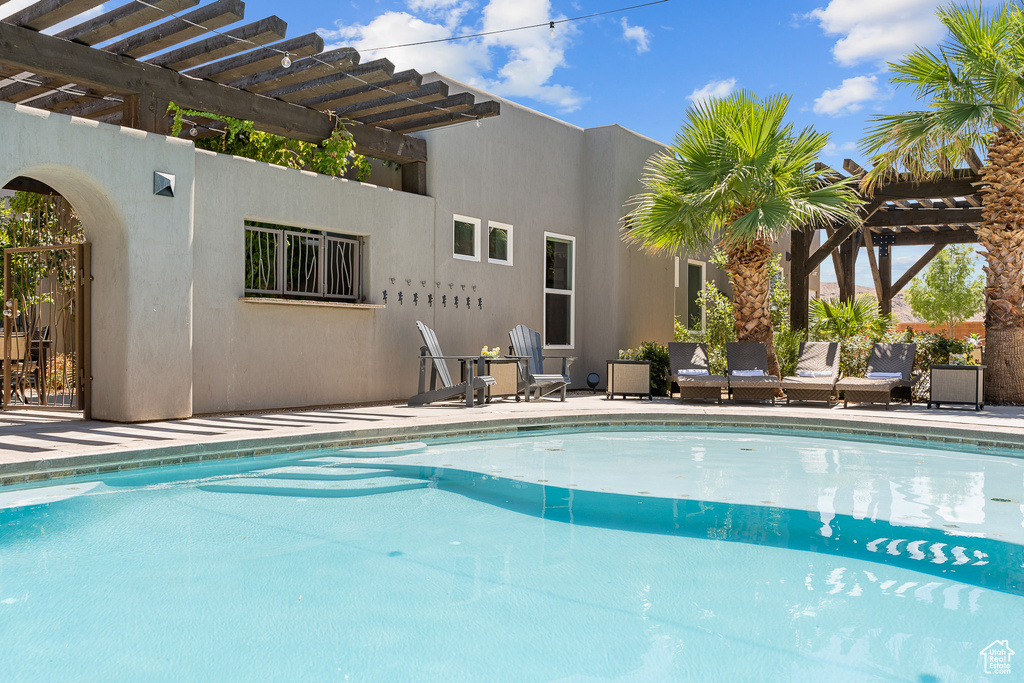 Outdoor pool featuring a pergola