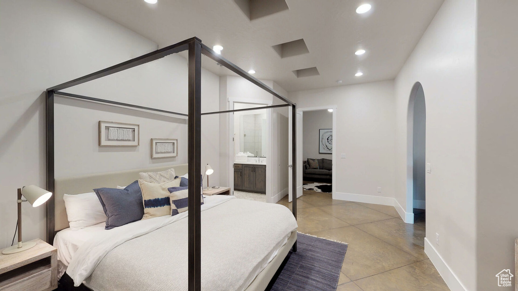 Bedroom featuring recessed lighting, finished concrete flooring, and arched walkways