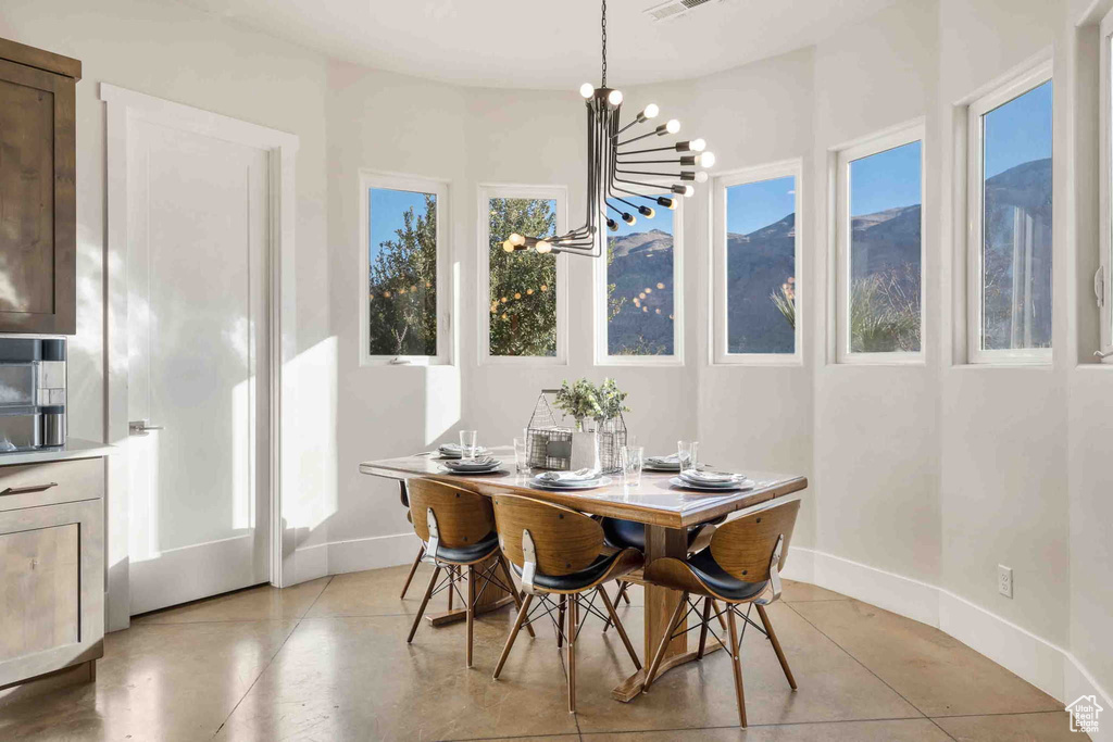 Dining space with a chandelier and baseboards
