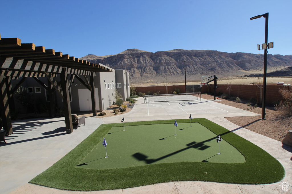 View of home\'s community featuring a putting area, a mountain view, and a tennis court