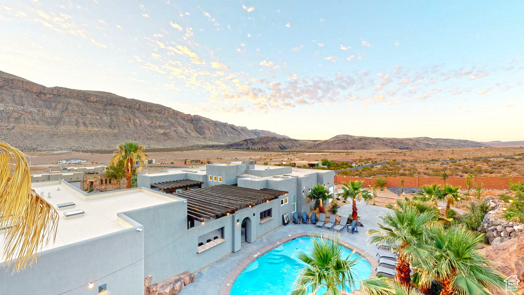 View of pool with a mountain view and a patio area