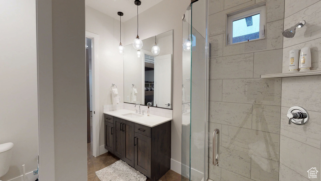 Full bath featuring a shower stall and vanity