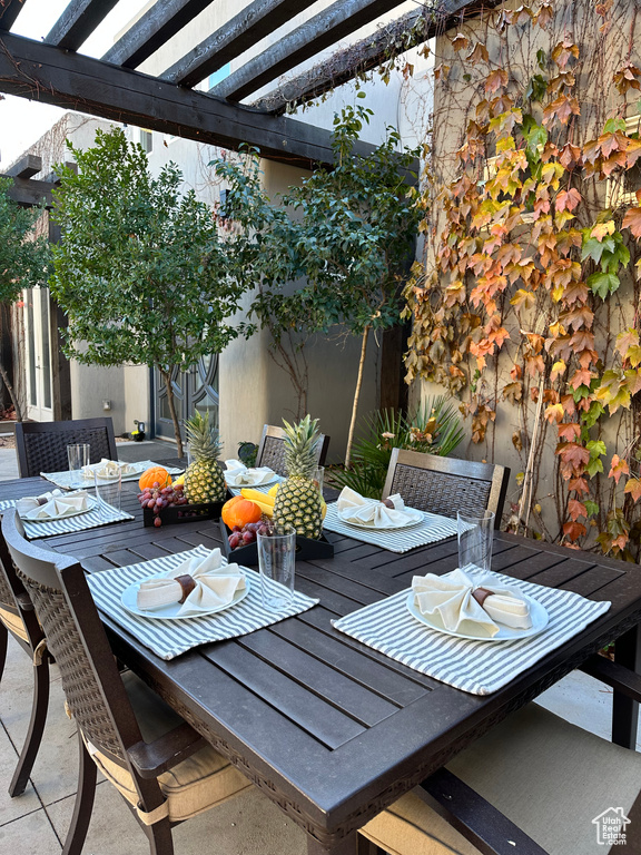 View of patio featuring outdoor dining space and a pergola