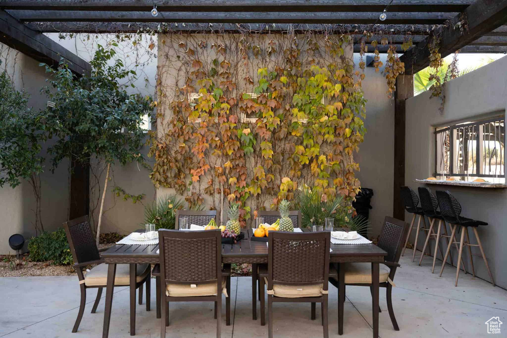 View of patio / terrace featuring a pergola and outdoor dining space