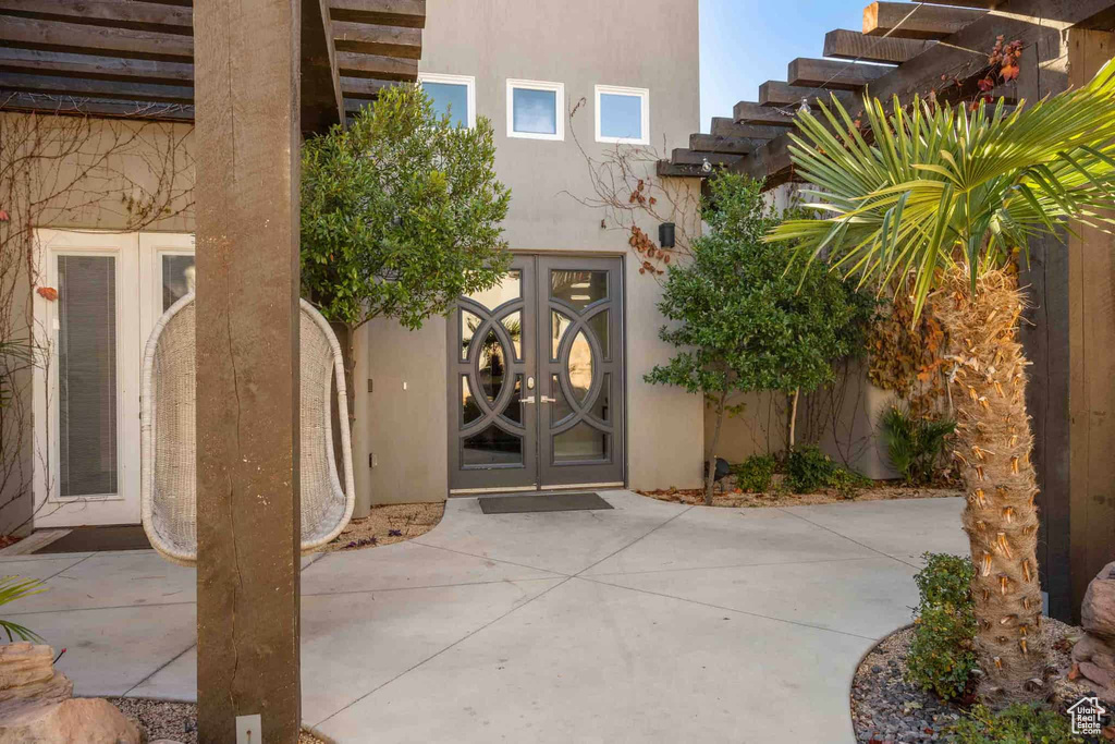 Entrance to property with french doors and stucco siding