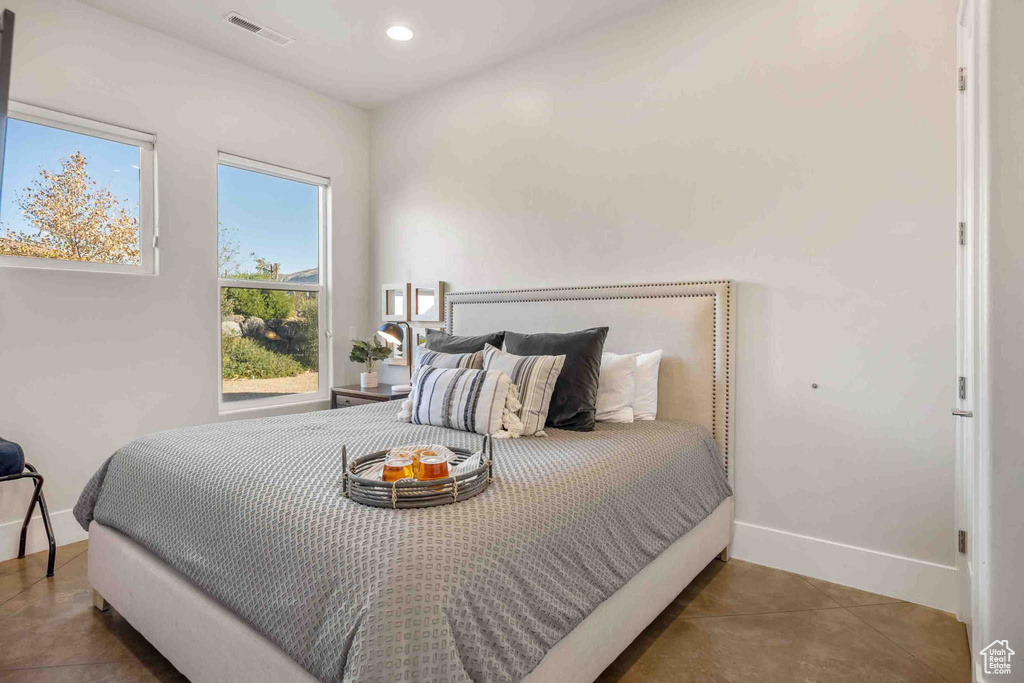 Bedroom with tile patterned floors and recessed lighting