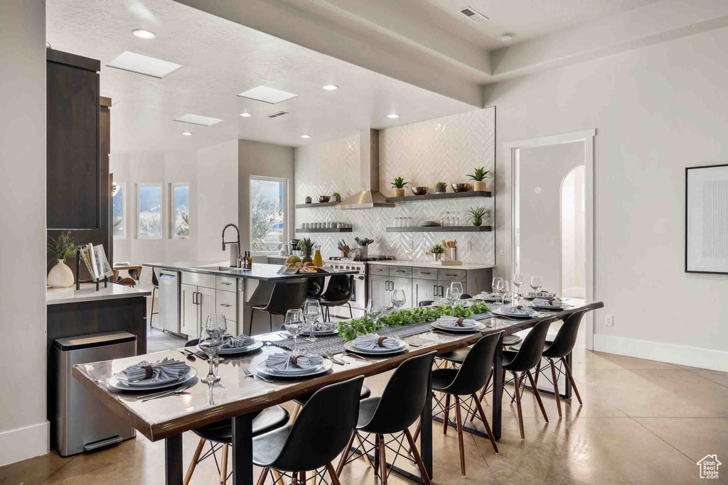Dining room featuring light tile patterned floors and recessed lighting