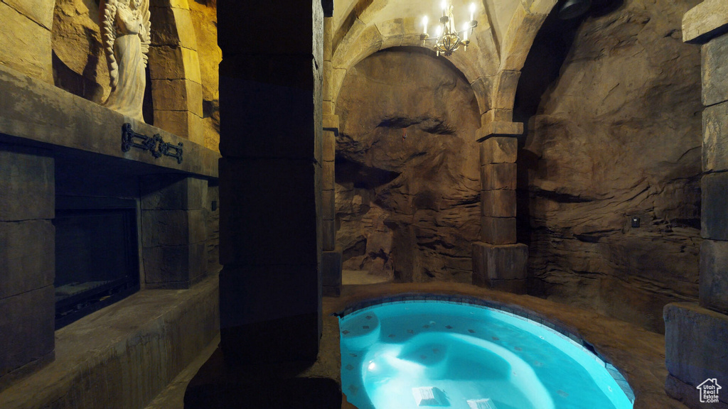 View of swimming pool with a chandelier