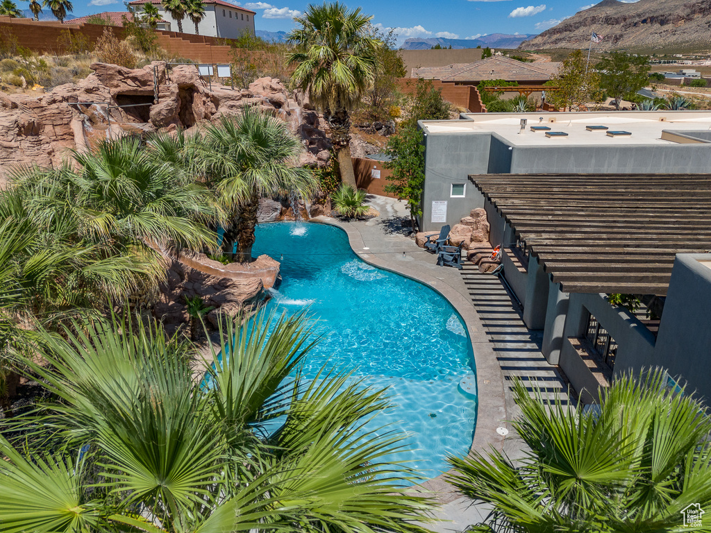 View of swimming pool with a mountain view and a patio