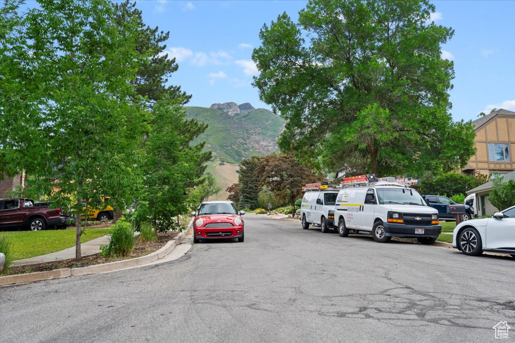 View of asphalt street with a mountain view and curbs