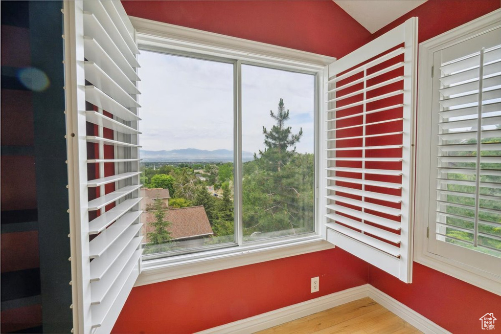 Unfurnished sunroom featuring plenty of natural light and vaulted ceiling