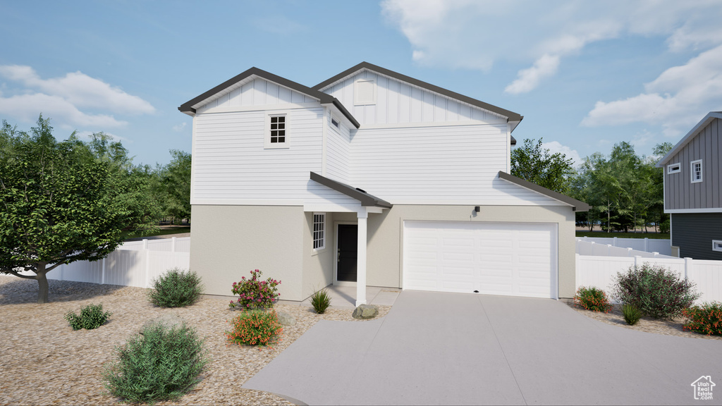 View of front of house featuring board and batten siding, concrete driveway, and a garage