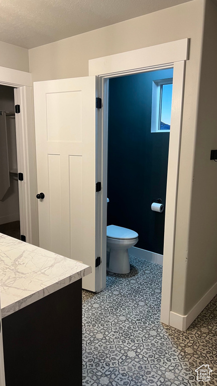 Bathroom with vanity and a textured ceiling