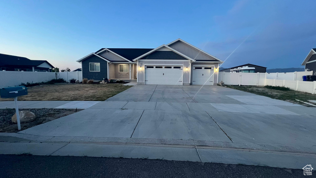 View of front of home featuring a garage, driveway, and board and batten siding