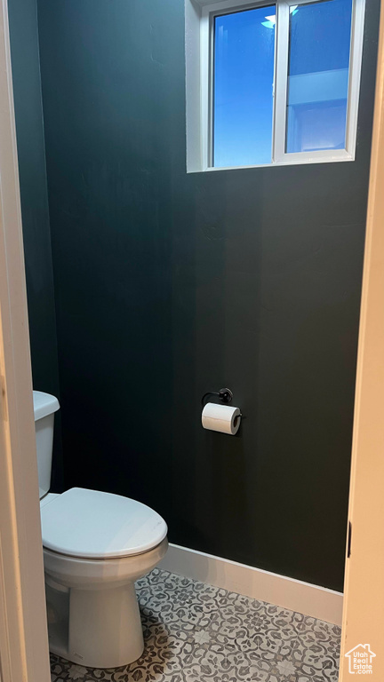 Bathroom with toilet and tile patterned flooring