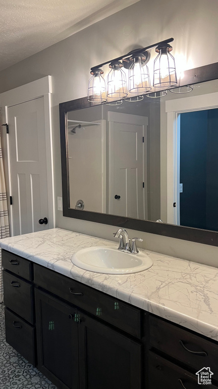 Bathroom with vanity and a textured ceiling