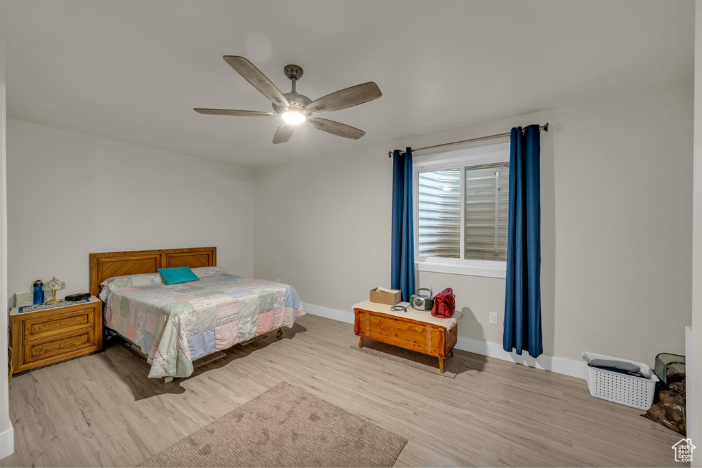 Bedroom with light wood-style floors and ceiling fan