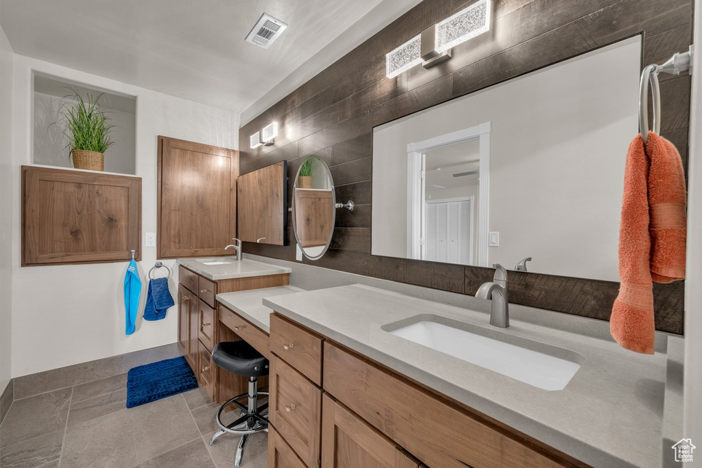 Full bath featuring vanity and tile patterned flooring