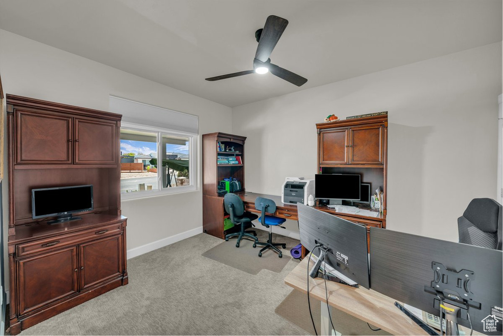 Carpeted office with ceiling fan and baseboards