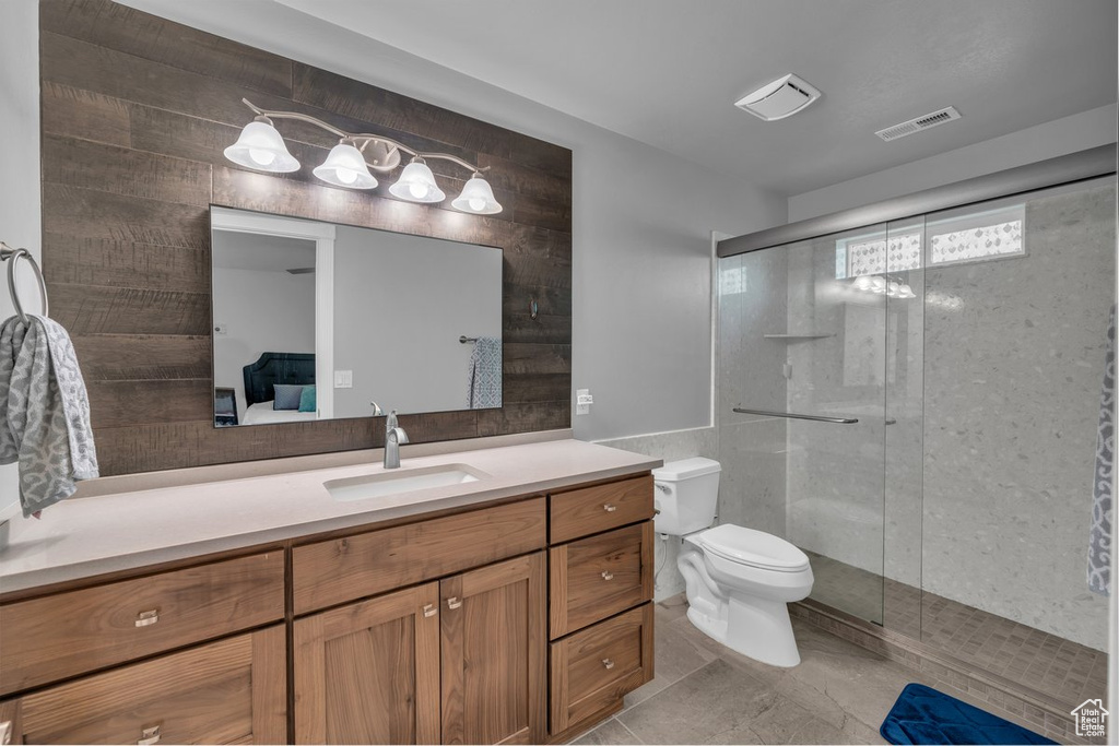 Bathroom featuring vanity, a shower stall, connected bathroom, and tile patterned flooring