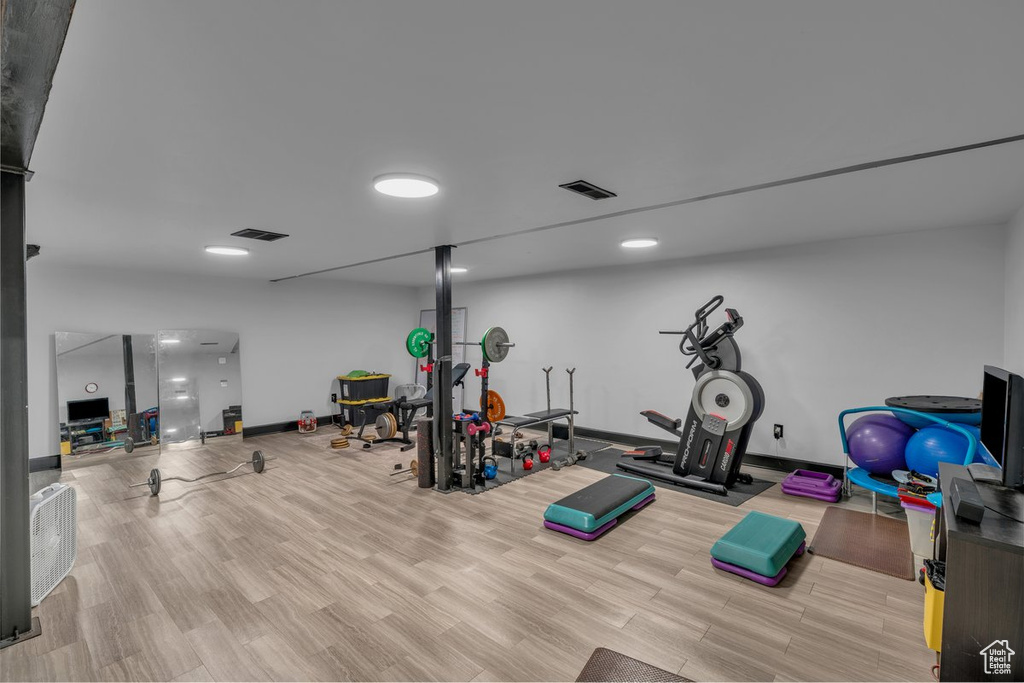 Exercise room featuring wood finished floors and baseboards