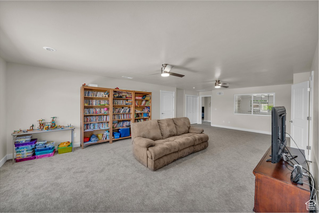 Living room with carpet flooring and a ceiling fan