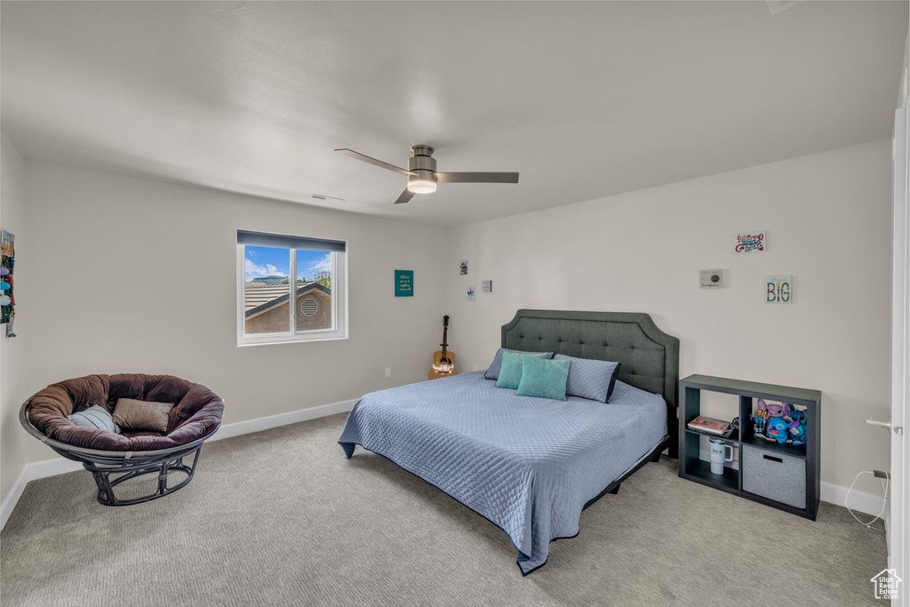 Bedroom featuring light colored carpet and ceiling fan