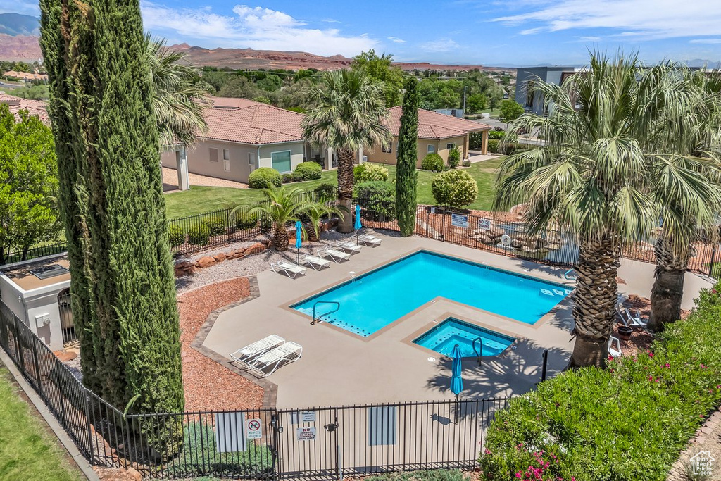 Community pool with a patio area and a mountain view