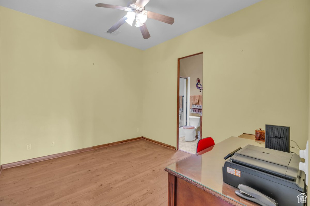 Office area featuring light wood-style floors and a ceiling fan
